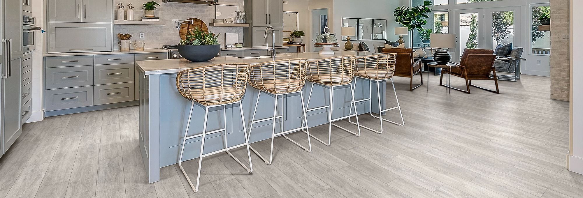 blue kitchen island and brown chairs in a kitchen with gray laminate floor from Michaels Carpets Huntington Beach in Huntington Beach, CA