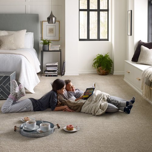 Kids reading book on the carpet floor provided by Michaels Carpets Huntington Beach in Huntington Beach, CA