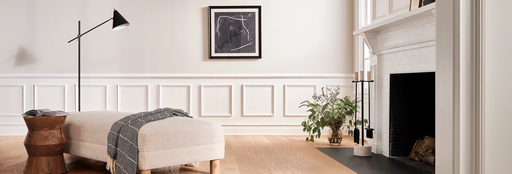 white armchair on brown hardwood floor by Michaels Carpets Huntington Beach in Huntington Beach, CA